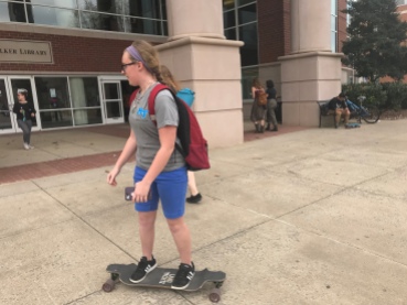Skateboard: Mattie Ford, a junior majoring in film and production, skateboards to the library to tackle some homework on March 30, 2018. (MTSU Sidelines/Taylor Riley)
